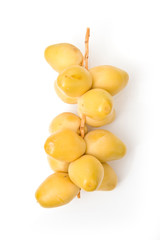 Fresh yellow dates isolated on a white studio background.