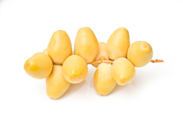 Fototapeta na wymiar Fresh yellow dates isolated on a white studio background.