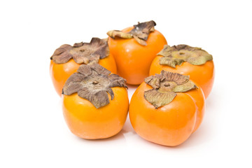 Sharon fruit isolated on a white studio background.