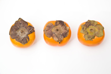 Sharon fruit isolated on a white studio background.