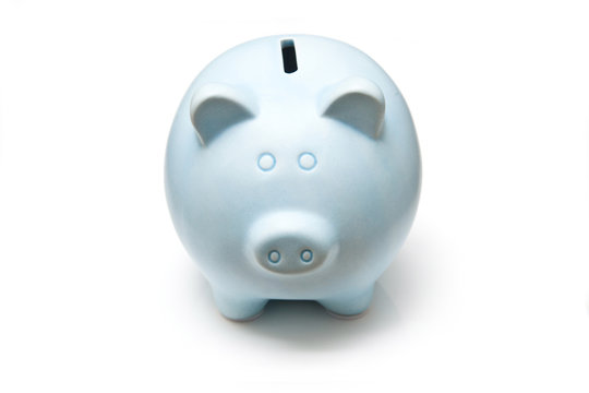 Blue piggy bank isolated on a white studio background.