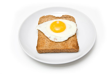 Fried egg on toast isolated on a white studio background.