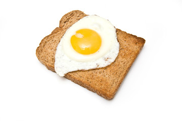 Fried egg ion toast isolated on a white studio background.