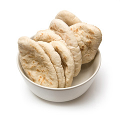 Bowl of pitta bread isolated on a white studio background.