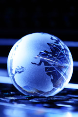 Figures and letters inside glassy globe on dark background