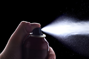 deodorant in hand isolated on black