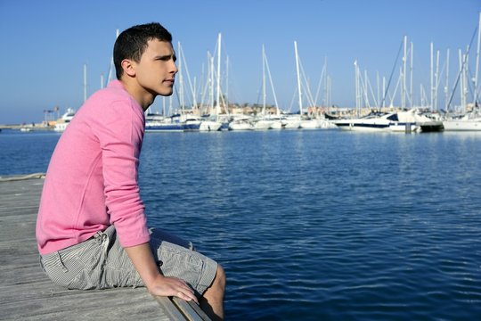 Handsome young man on summer in harbor