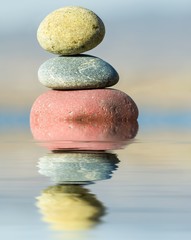 reflection in the water of the stone on a background sky