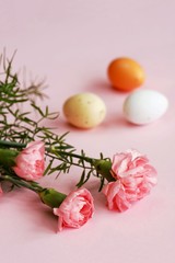 Fototapeta na wymiar Pink carnation and easter eggs