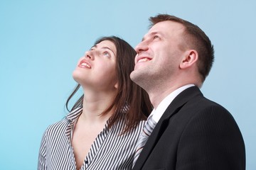 Business people standing against blue background.