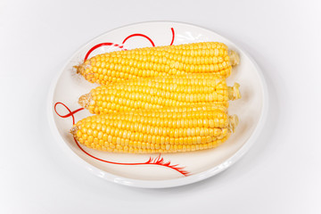 three corn on a porcelain dish