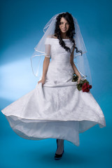 Brunette bride with red roses