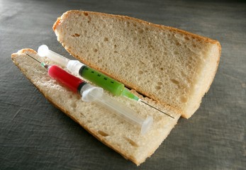two syringe in a bread sandwich