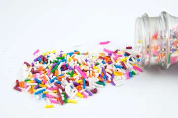Spilled sprinkles isolated on white.