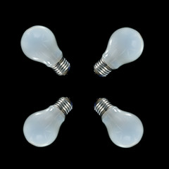 Four incandescent lamps on a black background