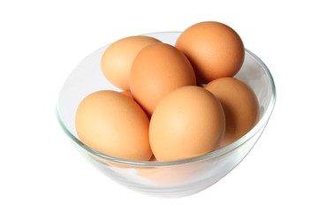 Colored eggs in glass bowl.