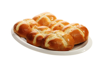 Easter hot cross buns stacked on a flat plate