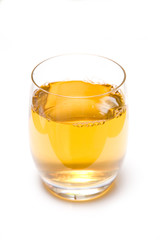 Glass of apple juice on a white studio background
