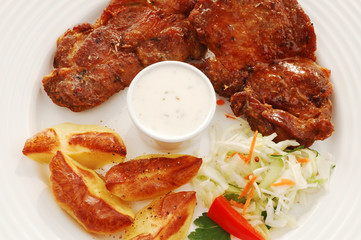 Grilled meat with baked potatoes and vegetable salad