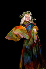 blond woman wrapped in colorful silk wearing wreath
