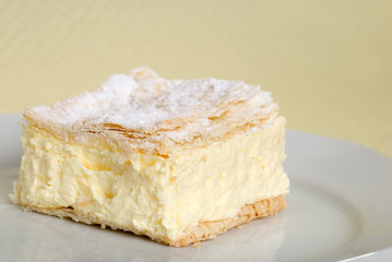 close up of custard cake square on a plate