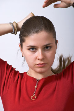 Young girl making her hair