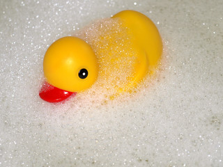 A yellow rubber duck surrounded by bubbles