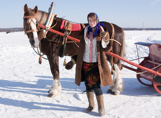 girl in  traditional clothes and horse-drawn