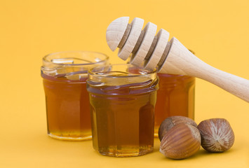 hazelnuts, honey and wooden drizzler