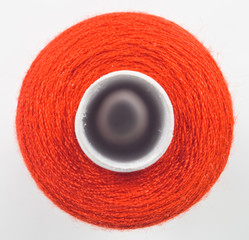 closeup of one red sewing spool
