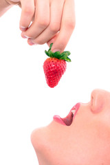 Obraz premium Beautiful girl holding strawberry