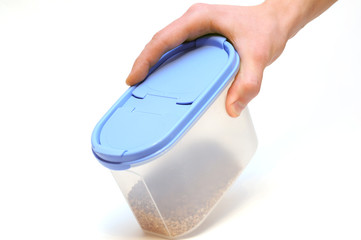 Hand holding plastic food container isolated