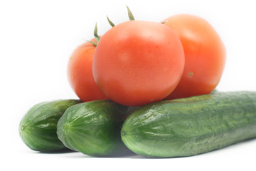 Cucumbers and tomatoes on white