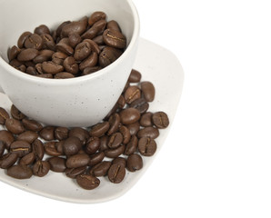 Cup with coffee beans isolated on white