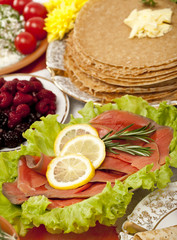 feast table: pancake with different dishes