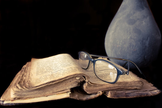 Ancient prayer book and glasses