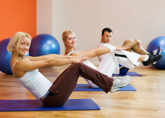 Group of people doing fitness exercise with a ball