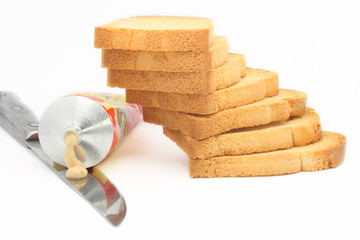 Rusk stack with mustard tube and knife