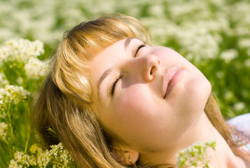 Young girl enjoying the sun on grass