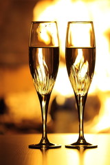two glasses in front of fireplace