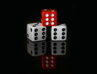 red and white dice reflected on black