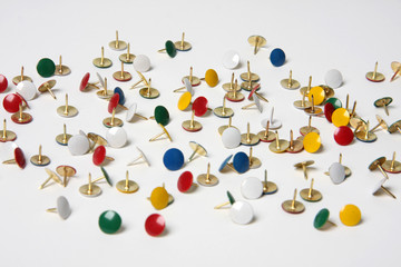 Colourful scattered drawing pins