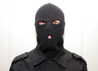 an burglar wearing a ski mask (balaclava)