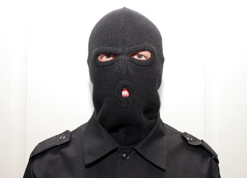 An Burglar Wearing A Ski Mask (balaclava)