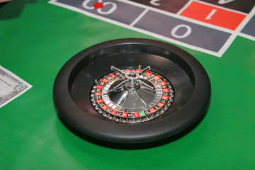 casino roulette on green cloth