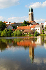 Tower and Houses with Lake Reflection