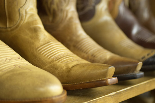 Close-up of new cowboy boots on shelf.