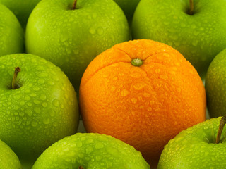 Wet Green Apples and Orange Background