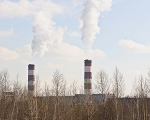 Thick smoke from the pipes against the backdrop of blue sky