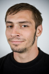 beardy male smiling in a portrait